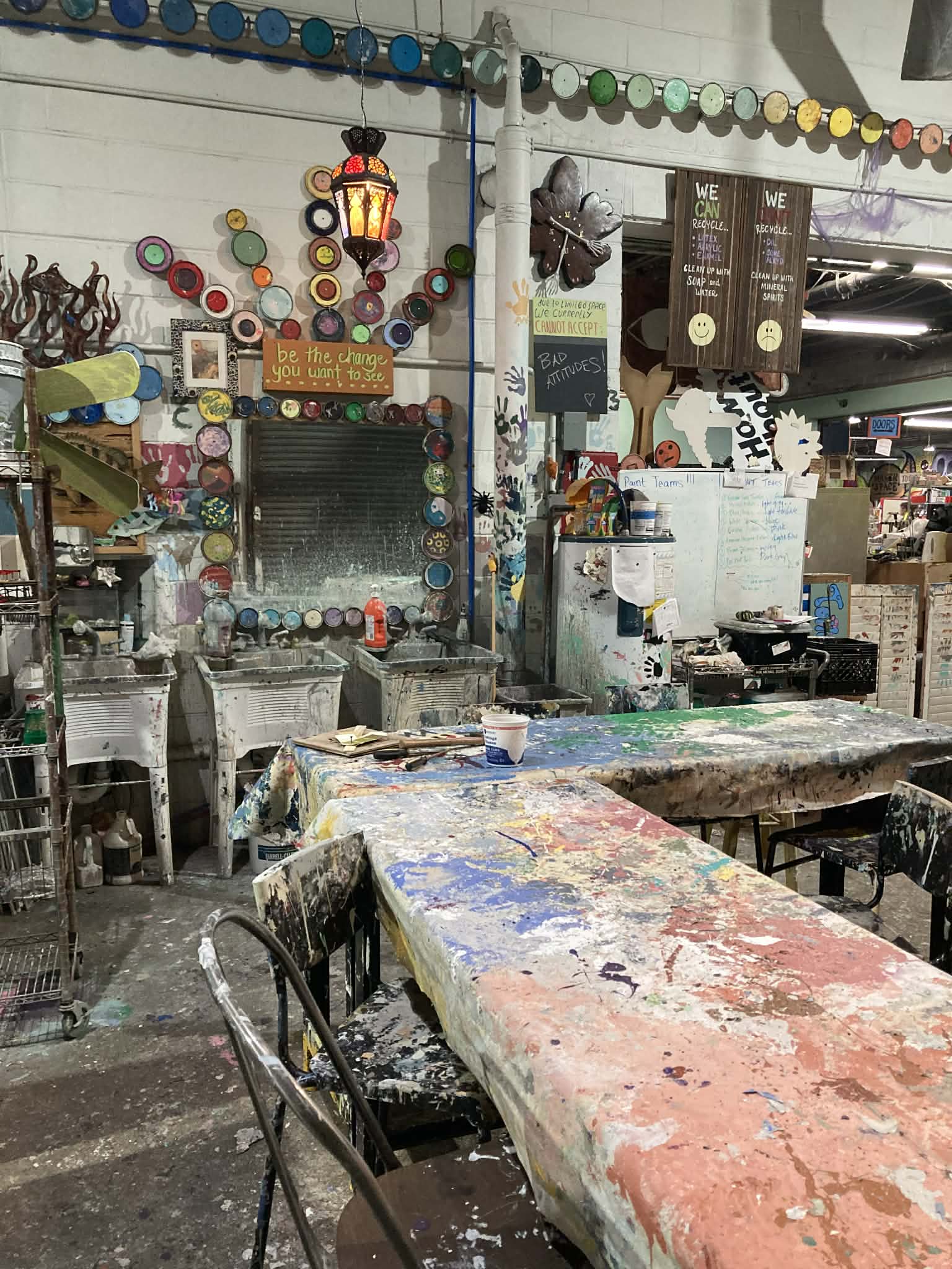 The Green Project workspace with inspirational messages and paint can decorations